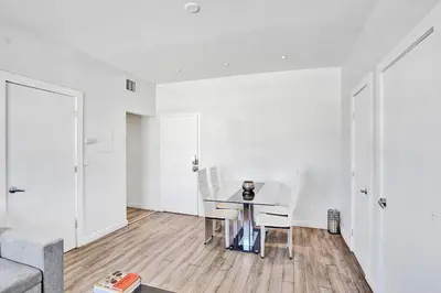 a white living room with a table and chairs at Miami Beach Home, 7 guests, Steps from the beach in Miami Beach