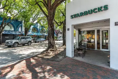 a store with a sign on the side of a street at Renovated Coconut Grove Studio includes Parking in Miami