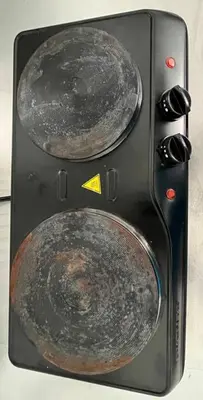 a stove with two pots and pans on it at Walk to the beach, Studio, Pool AND FREE Parking in Hallandale Beach
