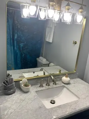a bathroom with a sink and a large mirror at Walk to the beach, Studio, Pool AND FREE Parking in Hallandale Beach