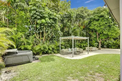 a garden with an outdoor pavilion in the grass at Luxury Miami Retreat in North Miami