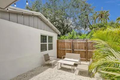a patio with a bench and a fence at Luxury Miami Retreat in North Miami