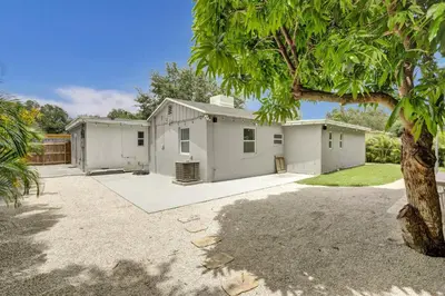 a white house with a tree in front of it at Luxury Miami Retreat in North Miami