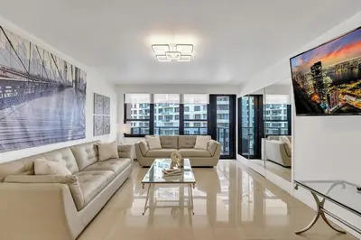 a living room with a couch and a table at Cozy Ocean View Condo Beach Service 617 in Miami Beach