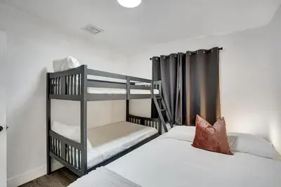 a bedroom with two bunk beds and a ladder at Beautiful Home in Maimi in Miami