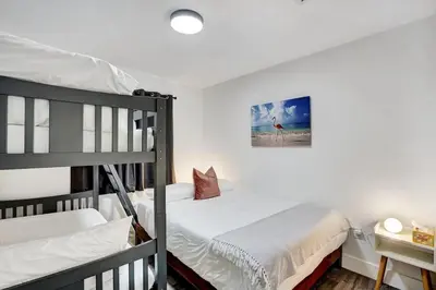 a bedroom with two bunk beds and a desk at Beautiful Home in Maimi in Miami