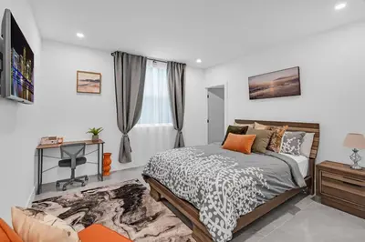 a bedroom with a bed and a desk and a window at Paraiso House Pool 10 Ppl 6 mins Coconut Grove in Miami