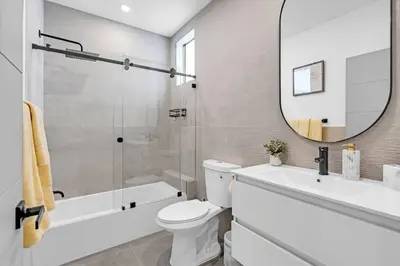 a bathroom with a toilet and a sink and a mirror at Paraiso House Pool 10 Ppl 6 mins Coconut Grove in Miami