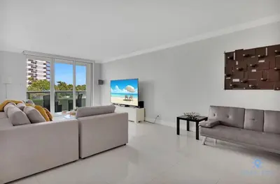 a living room with a couch and a table at Beautiful apartment with pool and gym in Hollywood