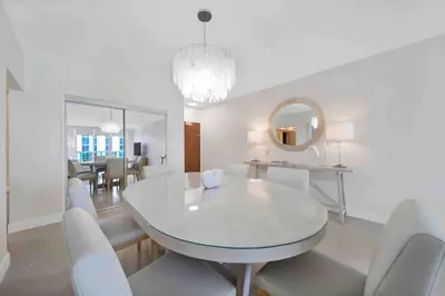a white dining room with a white table and chairs at Luxe Hollywood Beachfront Condo in Hollywood