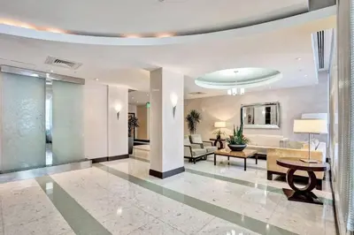 a living room with a lobby with a table at Luxe Hollywood Beachfront Condo in Hollywood