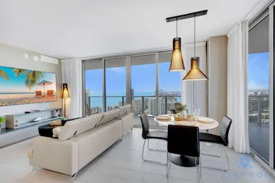 a living room with a white couch and a table at High Floor 3BR - 2BA - Resort Fees & Parking Incl in Hollywood