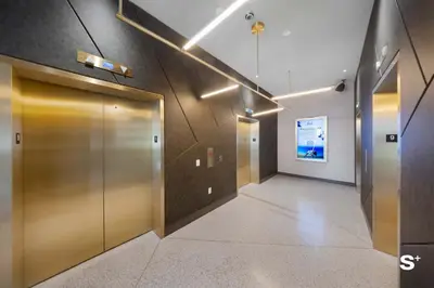 a hallway with two elevators in a building at Modern 1BD & Den With City Views in Miami