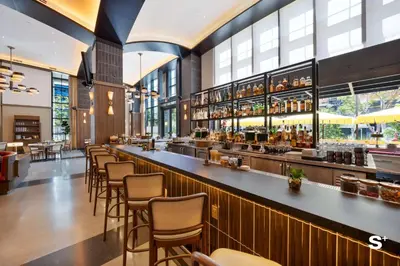 a bar in a restaurant with chairs and tables at Modern 1BD & Den With City Views in Miami