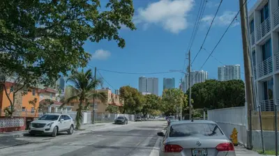 a street with cars parked on the side of the road at Stylish 3 Bedroom Miami Retreat Close Brickell in Miami