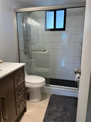 a bathroom with a toilet and a glass shower at Beautiful Water View Golden Isles in Hallandale Beach