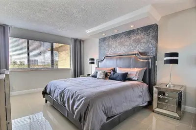 a bedroom with a large bed and a large window at Golden Isles # 509 in Hallandale Beach
