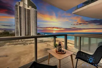 a balcony with a view of the beach and the ocean at Amazing Apartment Oceanview Beautiful Amenities in Sunny Isles Beach