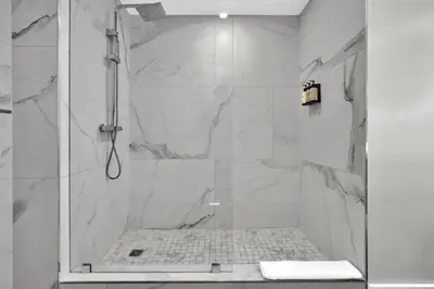a bathroom with a shower with a glass door at 2bedroom City Ocean Treasure in Miami
