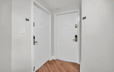 a hallway with white walls and two doors at 2bedroom City Ocean Treasure in Miami