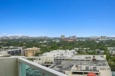 a view of the city from the balcony of a building at Find Tranquility in the Grove in Miami