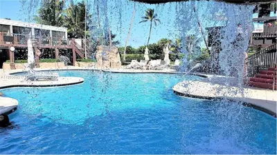 a swimming pool with a fountain in a resort at Beautiful 2 Br Apartment Amazing Pool in Miami Beach