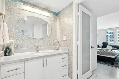 a bathroom with a sink and a mirror at Romantic-5 star-1BR-Oceanfront-Balcony-South-Beach in Miami Beach