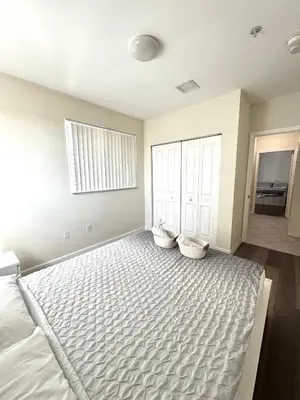 a bedroom with a large bed with two pillows on it at Private bedroom in Miami - Coral Gables 601 in Miami