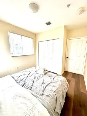 a bed in a bedroom with two windows at Private bedroom in Miami - Coral Gables 601 in Miami