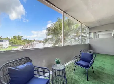 a balcony with chairs and a view of the beach at Cordova Arms By Rocketstay in Fort Lauderdale