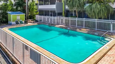 a large swimming pool with a fence around it at Cordova Arms By Rocketstay in Fort Lauderdale