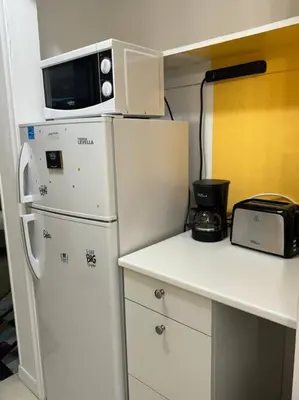 a kitchen with a white refrigerator and a microwave at Studio with Terrace Near Hard Rock-Patio in Fleetwood Manor