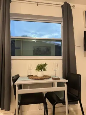 a table and chairs in a room with a window at Studio with Terrace Near Hard Rock-Patio in Fleetwood Manor
