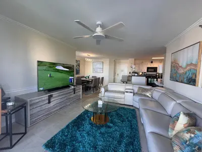 a living room with a couch and a flat screen tv at The Costal, stunning water view apartment at Aventura Yacht Club, Miami Florida! in Sun Swept Isles
