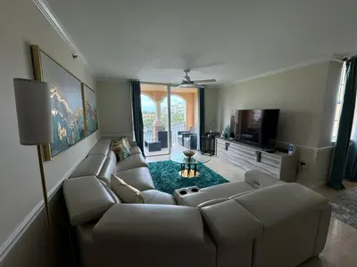 a living room with a couch and a tv at The Costal, stunning water view apartment at Aventura Yacht Club, Miami Florida! in Sun Swept Isles