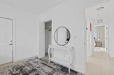 a white room with a mirror and a dressing table at Villa Verde - Your Exclusive Luxury Escape with Private Pool and Mini Golf in Miami