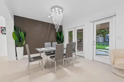 a dining room with a table and chairs at Villa Verde - Your Exclusive Luxury Escape with Private Pool and Mini Golf in Miami