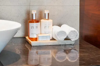 a bathroom with two bottles of soap and towels at 2 Bedroom Private Residence at Carillon Miami Resort -522 in Miami Beach