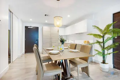 a dining room and kitchen with a table and chairs at Hollywood Beach Haven Rooftop Pool Hot Tub in Hollywood