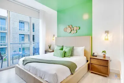 a bedroom with a bed and a large window at Hollywood Beach Haven Rooftop Pool Hot Tub in Hollywood