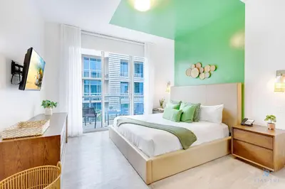 a bedroom with a bed and a large window at Hollywood Beach Haven Rooftop Pool Hot Tub in Hollywood