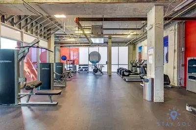 a gym with several treadmills and cardio machines at Hollywood Beach Haven Rooftop Pool Hot Tub in Hollywood