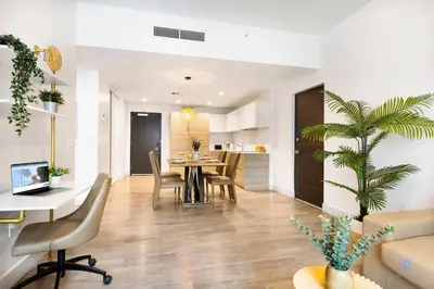 a living room and dining room with a table and chairs at Hollywood Beach Haven Rooftop Pool Hot Tub in Hollywood