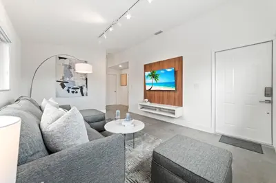 a living room with a couch and a table at Luxurious Family Escape in Hialeah