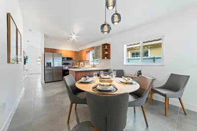 a kitchen and dining room with a table and chairs at Luxurious Family Escape in Hialeah