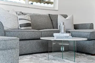 a living room with a couch and a table with books at Luxurious Family Escape in Hialeah