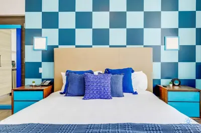 a bedroom with a bed and blue and white checkered wall at Luxurious Condo with Rooftop Pool Hot Tub in Hollywood