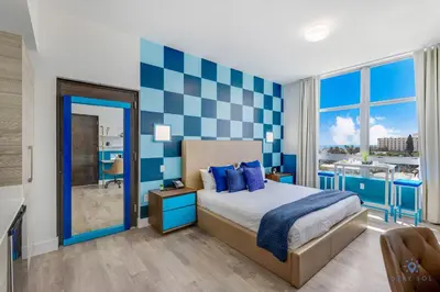 a bedroom with a blue and white checked wall at Luxurious Condo with Rooftop Pool Hot Tub in Hollywood