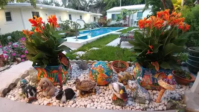 a garden with colorful vases and flowers in a yard at Downtown Hollywood Boutique Hotel in Hollywood