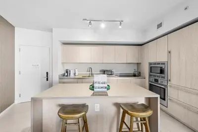 a kitchen with a large island with two bar stools at Breathtaking Ocean-View Balcony Lyfe Resort in Hollywood Beach